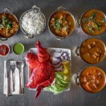 Delicious Indian food spread featuring vibrant tandoori chicken and aromatic curries.